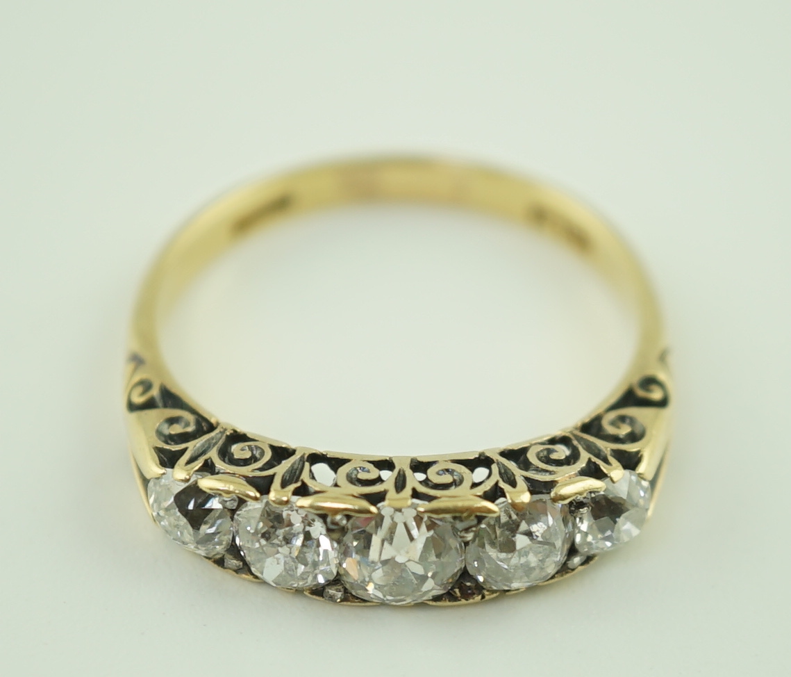 An early 20th century 18ct gold and graduated five stone old cut diamond set half hoop ring